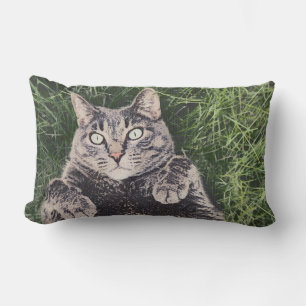 grey cat lying in the grass Throw Pillow