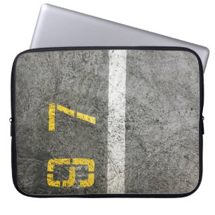 Grey concrete floor with 197 print laptop sleeve