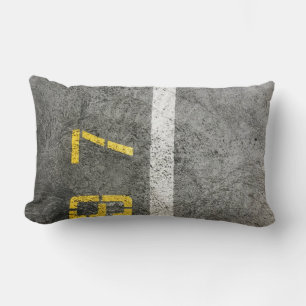 Grey concrete floor with 197 print lumbar cushion