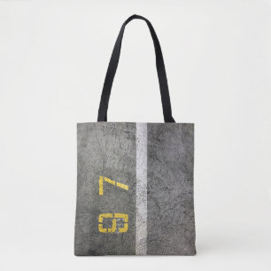 Grey concrete floor with 197 print tote bag