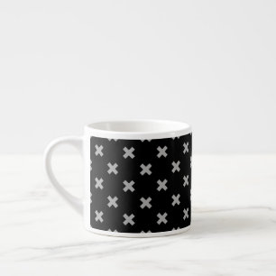 Grey cross stitches on black espresso cup