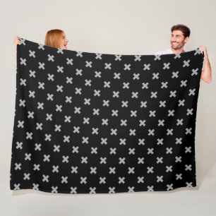 Grey cross stitches on black fleece blanket