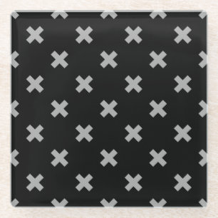 Grey cross stitches on black glass coaster