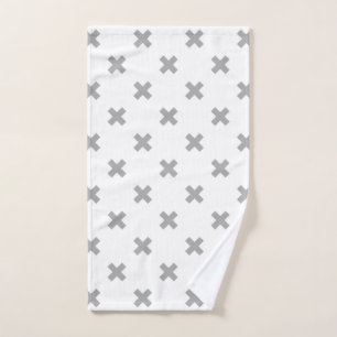 Grey cross stitches on white hand towel
