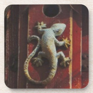 grey lizard on worn wood coaster