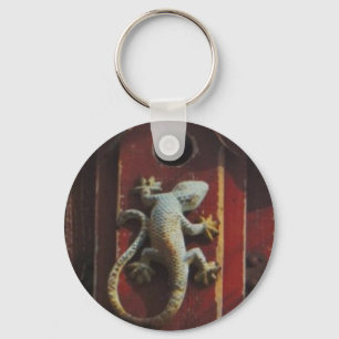 grey lizard on worn wood key ring