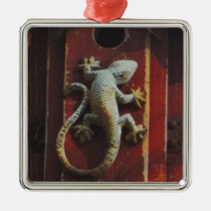 grey lizard on worn wood metal ornament