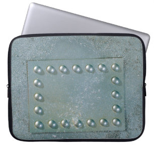 Grey metal with text plate on laptop sleeve