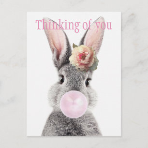 Grey rabbit blowing bubble gum with anemone flower postcard