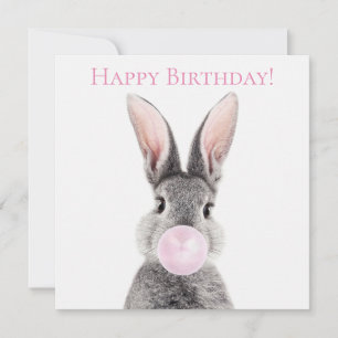 Grey rabbit blowing pink bubble gum