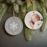 Grey Winter Snowflake First Christmas Keepsake Ceramic Ornament<br><div class="desc">Ceramic holiday ornament personalised with your baby's photo and custom "My First Christmas" text. This simple modern holiday design features a white snowflake on a grey background. Use the design tools to choose any background colour, edit text fonts and colours and add your own photos to create your own unique...</div>