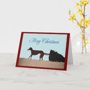 Greyhound pulling a Christmas Tree through Snow Card