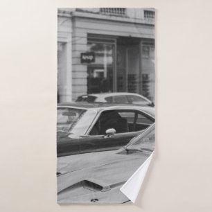 GREYSCALE PHOTOGRAPHY OF CARS ON ROAD BESIDE BUILD BATH TOWEL