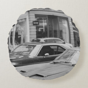 GREYSCALE PHOTOGRAPHY OF CARS ON ROAD BESIDE BUILD ROUND CUSHION