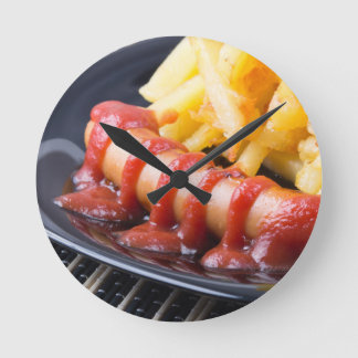 Grilled sausages and fried potato round clock