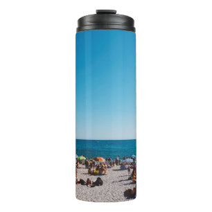 GROUP OF PEOPLE ENJOYING THE GRAY SANDED BEACH WIT THERMAL TUMBLER