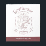 GRYFFINDOR™ Determination Courage Bravery Crest Notepad<br><div class="desc">Show your house pride with this bold Gryffindor™ crest design, celebrating the values that define the bravest of witches and wizards. Featuring the iconic lion standing proudly before a shield, this striking artwork highlights Gryffindor’s core traits — Courage, Determination, and Bravery — in a powerful, vintage-inspired layout. The rich house...</div>