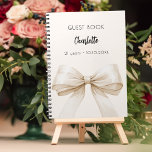 Guest book beige cream bow birthday<br><div class="desc">A beige,  cream background colour. Decorated with a large bow.  Personalise and add your name,  age.</div>