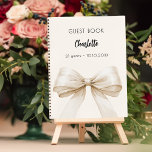 Guest book beige cream bow birthday<br><div class="desc">A beige,  cream background colour. Decorated with a large bow.  Personalise and add your name,  age.</div>