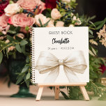 Guest book beige cream bow birthday<br><div class="desc">A beige,  cream coloured background colour. Decorated with a large bow.  Personalise and add your name,  age.</div>