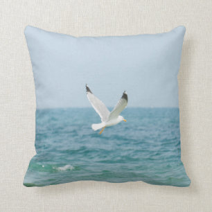 Gull flying above sea cushion