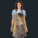 Gustav Klimt Lady with a Fan  Art Nouveau Apron<br><div class="desc">Gustav Klimt's "Lady with a Fan" is a mesmerising portrait that captures the essence of the Jugendstil and Art Nouveau movements. The painting features a regal woman, her gaze direct and confident, holding an ornate fan in her hand. She is adorned in a dress that is a symphony of rich...</div>