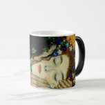 Gustav Klimt - The Kiss Magic Mug<br><div class="desc">The Kiss (in German Der Kuss) is an oil-on-canvas painting with added gold leaf, silver and platinum by the Austrian symbolist painter Gustav Klimt. The painting depicts a couple embracing each other, their bodies entwined in elaborate beautiful robes decorated in a style influenced by the contemporary Art Nouveau style and...</div>