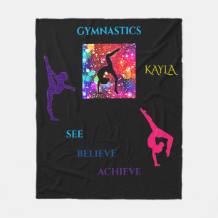 Gymnastics designs on a black fleece blanket.