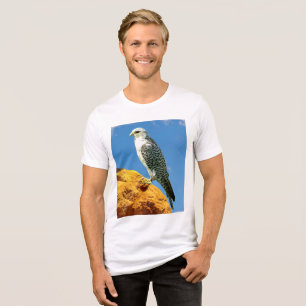 Gyrfalcon perched on a rock Tri-Blend shirt