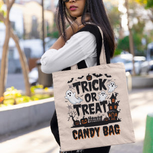 Halloween display with ghosts, pumpkins tote bag