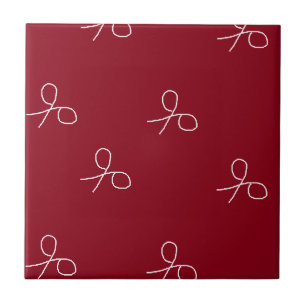 Hand drawn scissors on maroon red ceramic tile