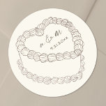 Hand Drawn Vintage Cake Wedding Classic Round Sticker<br><div class="desc">Personalized Vintage Cake Wedding Monogram Stickers. These custom round wedding stickers feature a soft ivory background with tan artwork and text for an elegant, muted look. A simple vintage-style cake illustration sits at the center, topped with the couple’s monogram initials and wedding date for a timeless and refined touch. The...</div>