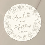 Hand Drawn Whimsical Wedding Classic Round Sticker<br><div class="desc">Personalised Hand-Drawn Quirky Wedding Stickers. These fun and playful round wedding stickers feature quirky doodle illustrations surrounding the edges in soft tan against a crisp ivory background, creating an elegant, muted look. Elements like a champagne tower, wedding cake, disco ball, hearts, wedding bells, rings, cameras, and more are rendered in...</div>