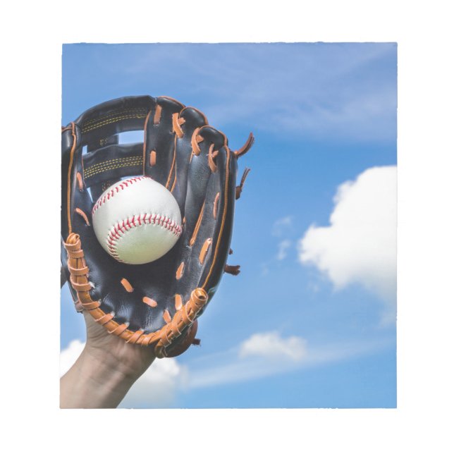 Hand holding baseball in glove with blue sky notepad (Front)