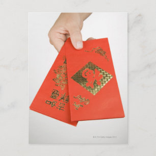 Hand holding Chinese money envelope Postcard