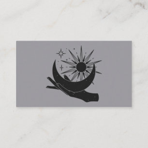 Hand holding moon and sun business card