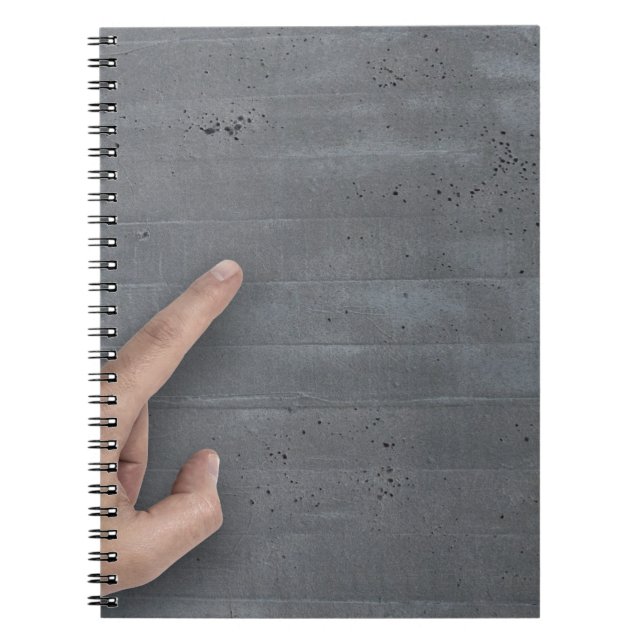 Hand showing concept on copy space template notebook (Front)