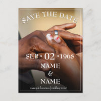 Hands of a coloured wedding couple pin on ring