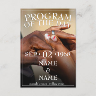 Hands of a coloured wedding couple pin on ring enclosure card