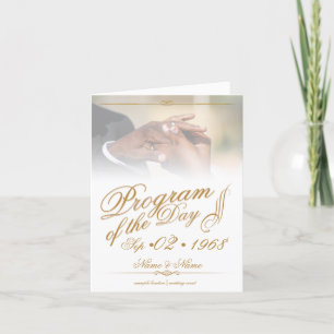 Hands of a coloured wedding couple pin on ring gol announcement