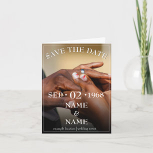 Hands of a wedding couple with a ring card