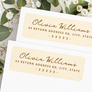 Handwritten script cream coloured return address label