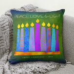 Hanukkah Bold Blue Candles Green Peace Love Light Cushion<br><div class="desc">“Peace, love & light.” A playful, modern, artsy illustration of boho pattern candles in a menorah helps you usher in the holiday of Hanukkah. Assorted blue candles with colourful faux foil patterns overlay a rich, deep green textured background. Faux copper pattern foil on a rich dark green background for the...</div>