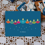 Hanukkah Card | Colourful Oil Lamp Menorah | Teal<br><div class="desc">Celebrate Hanukkah with a vibrant and contemporary greeting card design. This menorah is formed from colourful bowl-shaped oil lamps, each with a glowing flame, arranged in a cheerful display. The centre lamp highlights a faux-foil Star of David, adding both meaning and elegance. Perfect for families who enjoy modern and artistic...</div>