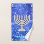 Hanukkah Snowstorm Menorah Hand Towel<br><div class="desc">A glowing gold Hanukkah menorah superimposed on a blue and white fractal image reminiscent of snowflakes in a storm. Hebrew text reading "Chag Chanukkah Sameach " (Happy Hanukkah) also appears in glowing blue and white.Chag Sameach!</div>