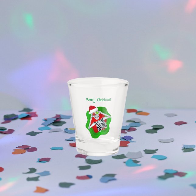 Happy Christmas Skeleton in Wavy Bright Circle Hat Shot Glass (Merry Christmas skeleton ornament eyes red green wavy circle on shot glass.)