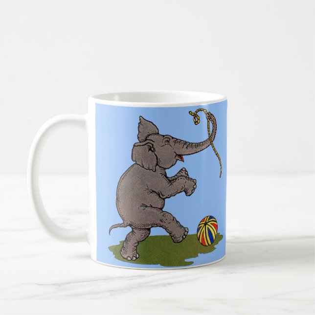 happy elephant playing with rope and ball coffee mug (Left)