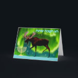 Happy Hanukkah - Northern Lights Moose Holiday Card<br><div class="desc">Chanukkah greetings from the Frozen Chosen. A Chanukkah menorah and an ever so slightly stylised image of a moose silhouetted against the Northern Lights.  Hebrew text reading,  "חנוכה שמח חג" (Chag Chanukkah Sameach - Happy Hanukkah) appears in in glowing blue and white.</div>