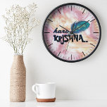 "Hare Krishna" Peacock Feather Hindu Clock<br><div class="desc">Introducing the "Hare Krishna" Peacock Feather Hindu Clock, a beautiful blend of devotion and elegance for your home. This exquisite clock features a stunning design with vibrant peacock feathers, symbolising Lord Krishna's divine beauty and grace. The phrase "Hare Krishna" is prominently displayed, adding a spiritual touch to this functional piece....</div>