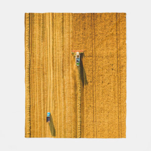 Harvester machine working in field. Combine harves Fleece Blanket
